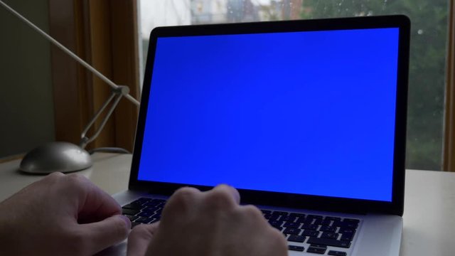 Medium shot of modern laptop croma key with rainy garden background