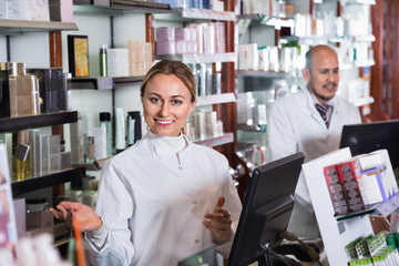 Female and male pharmacists working the pharmaceutical store