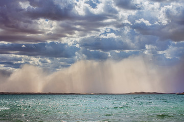 amazing view of azure sky over rippled surface of cold sea at sunrise
