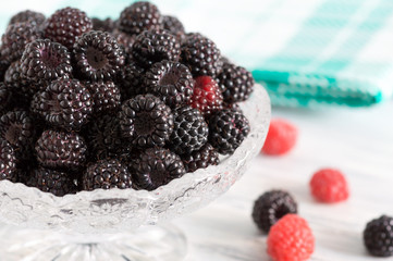 Black raspberry in a vase close-up. Appetizing fresh berry.