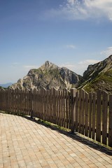 Fototapeta premium Wooden fence in the Alps under blue sky