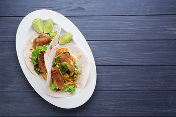 Delicious fish tacos on dark blue background
