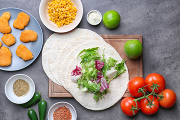 Ingredients for fish tacos on dark grey background