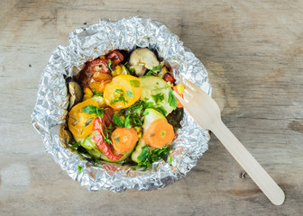 Vegetables zucchini, eggplant, tomato, carrot, bell pepper baked in the oven in foil.