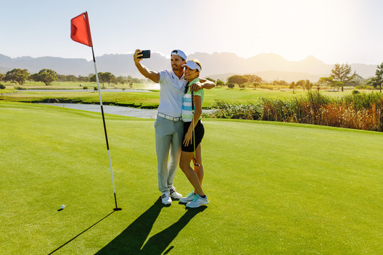 Couple of golfers making selfie at golf course