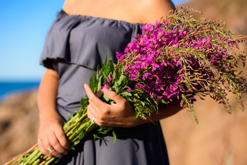 girl holding a willow-herb bouquet