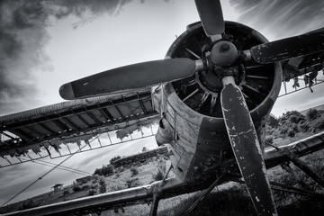 Old airplane on field in black and white