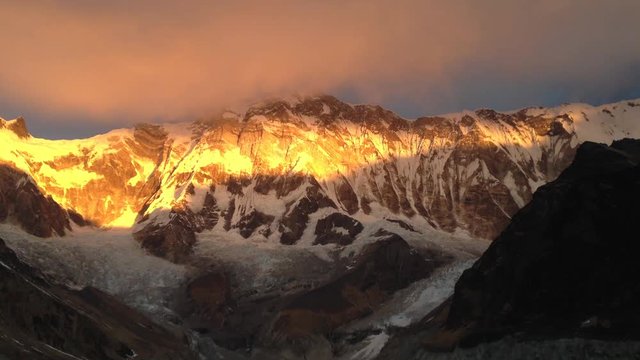 Timelapse with sunrise over Annapurna South with beautiful colours. Himalaya, Nepal
