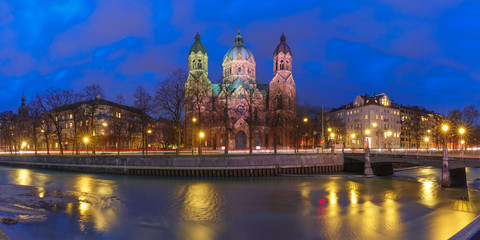 Fototapeta na wymiar Panorama of Saint Lucas Church, the largest Protestant church in Munich, and Isar River at night, Bavaria, Germany