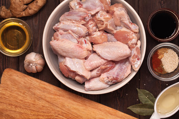 raw chicken wings on a wooden table.