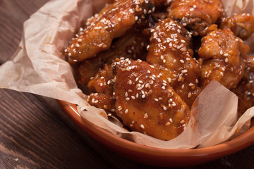 Chicken wings on a wooden table.