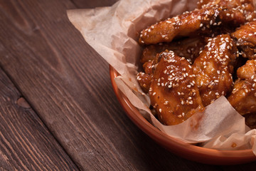 Chicken wings on a wooden table.