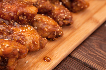 Chicken wings on a wooden table.