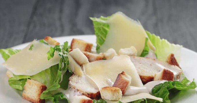 caesar salad with chicken on oak table