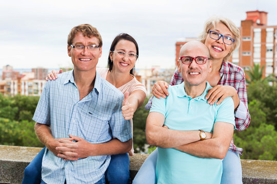 Portrait of smiling mature people in glasses outdoors together