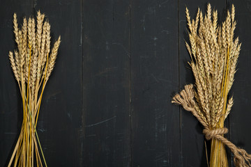 Wheat on a black wooden background. © denisk999