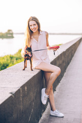 Beautiful teenage girl walking in the city in her doggy