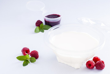 Dessert panacotta with berries in a plastic container