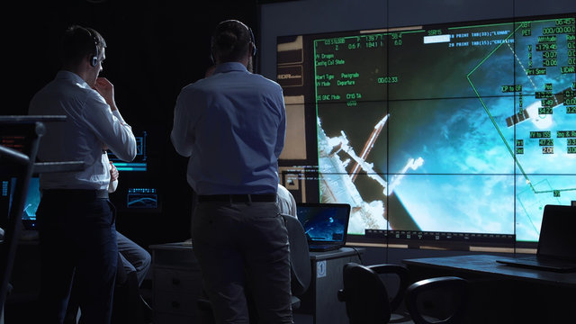 A group of people are controlling the orbiting international space station ISS. Elements of this image furnished by NASA.