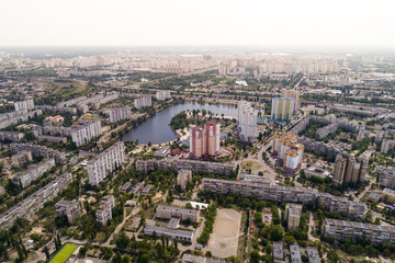 Fototapeta premium Residential district in a large metropolis with road junctions and houses. Aerial view. From above.