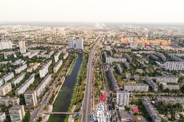 Fototapeta na wymiar Residential district in a large metropolis with road junctions and houses. Aerial view. From above.