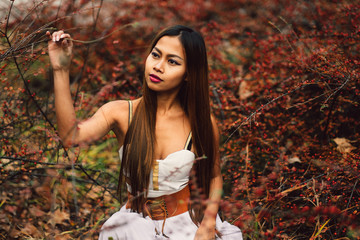 Fashion gorgeous young woman in beautiful white dress in a fairy-tale forest. magic atmosphere