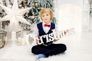 Little boy greets Christmas. Concept winter, lifestyle, Merry Christmas.