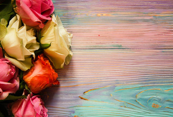 Colorful wooden background with red, pink and white roses