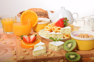 Strawberry orange and kiwi fruit on a dietetic breakfast  With yellow Swiss cheese andWhite french with mold and pepper