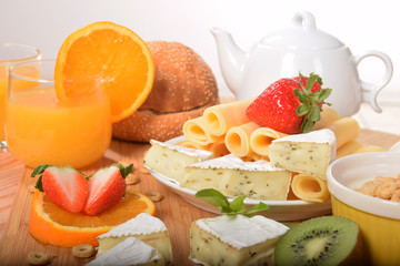 Strawberry orange and kiwi fruit on a dietetic breakfast  With yellow Swiss cheese andWhite french with mold and pepper
