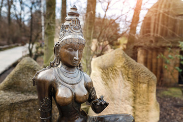 Fototapeta na wymiar Goddess Parvati hinduism shiva wife bronze sculpture in park