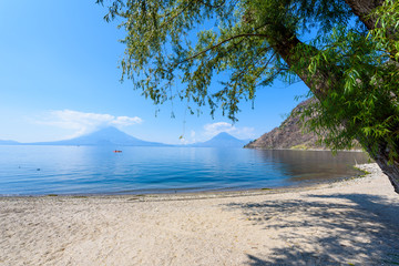 Paradise beach at lake Atitlan, Panajachel - Relaxing and recreation at beach with vulcano landscape scenery in the highlands of Guatemala