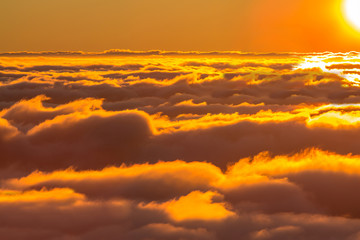 Sunset over the clouds