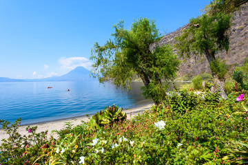 Paradise beach at lake Atitlan, Panajachel - Relaxing and recreation at beach with vulcano landscape scenery in the highlands of Guatemala