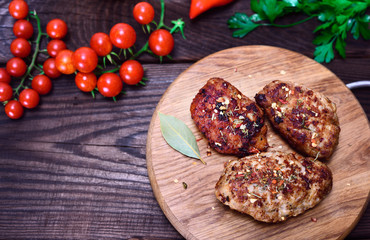 cutlets with spices on a wooden kitchen board