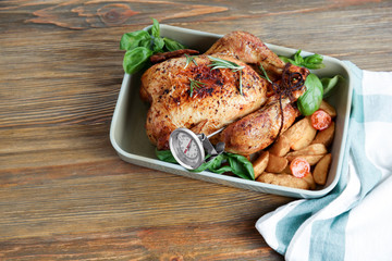 Golden roasted turkey with meat thermometer on table