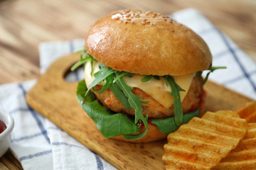 Tasty turkey burger on wooden board