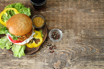 Tasty turkey burger on wooden board