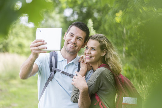 Hikers making pictures of themselves with a tablet