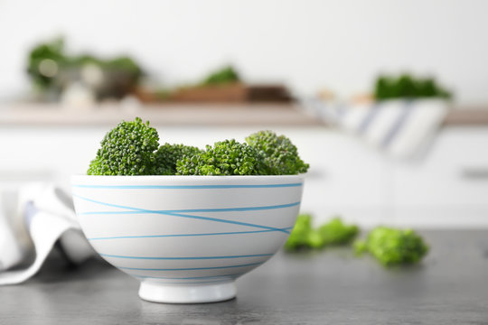 Fresh green broccoli sprouts in bowl on kitchen table