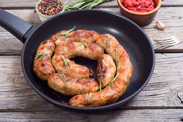 Homemade grilled sausages in pan