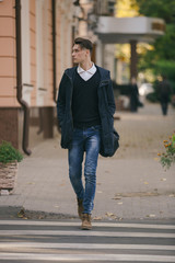 Hipster guy walking down the street, urban style