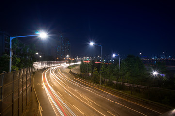 Fototapeta na wymiar Speed Traffic at Dramatic Sundown Time - light trails on motorway highway at night, long exposure. Seoul South Korea