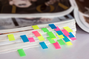 many colorful bookmarks in a magazine with the shallow depth of scene