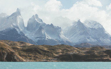 View of snowcapped mountain and lake against cloudy sky