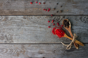 pepper mix in wooden spoons on rustic table, colorful indian spices