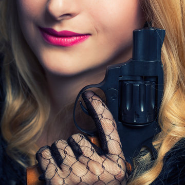 beautiful retro woman holding a revolver