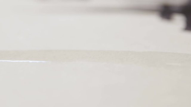 Macro Black Ink Drop Spreads in Horizontal Form on Thick Paper