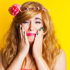 sad beautiful young woman wearing wreath against yellow background