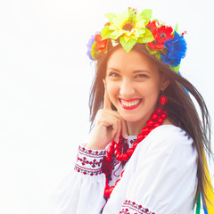 beautiful young woman wearing national ukrainian clothes posing outdoors